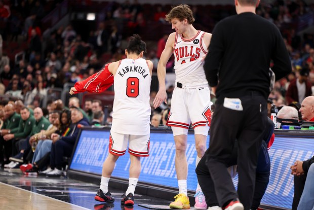Chicago Bulls forward Matas Buzelis (14) pats Chicago Bulls guard Yuki Kawamura (8) as he goes in for the first time in the game during the fourth quarter against the Milwaukee Bucks at the United Center on Sunday, March 1, 2026. (Eileen T. Meslar/Chicago Tribune)