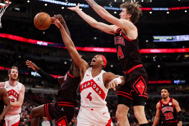 Chicago Bulls forward Leonard Miller (11) and Chicago Bulls forward Matas Buzelis (14) guard Toronto Raptors forward Scottie Barnes (4) during the first quarter at the United Center March 18, 2026 in Chicago. (Armando L. Sanchez/Chicago Tribune)