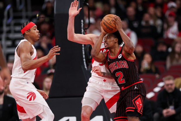 Toronto Raptors forward Sandro Mamukelashvili (54) and Toronto Raptors forward Scottie Barnes (4) guard Chicago Bulls guard Collin Sexton (2) during the first quarter at the United Center March 18, 2026 in Chicago. (Armando L. Sanchez/Chicago Tribune)