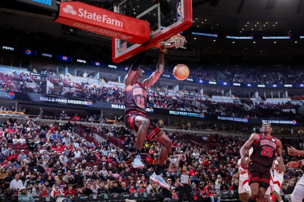 Chicago Bulls forward Leonard Miller (11) dunks the ball during the third quarter against the Toronto Raptors at the United Center March 18, 2026 in Chicago. (Armando L. Sanchez/Chicago Tribune)
