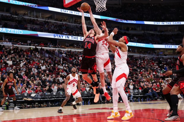 Toronto Raptors forward Sandro Mamukelashvili (54) blocks Chicago Bulls forward Matas Buzelis (14) from making a shot during the third quarter at the United Center March 18, 2026 in Chicago. (Armando L. Sanchez/Chicago Tribune)