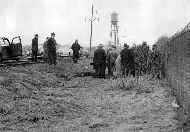 Police gather around Frank Nitti's body along a railroad embankment in North Riverside on March 19, 1943, after Nitti died by suicide. This photo looks north along the Illinois Central Railroad tracks, south of Cermak Road. (Ray Gora/Chicago Tribune)