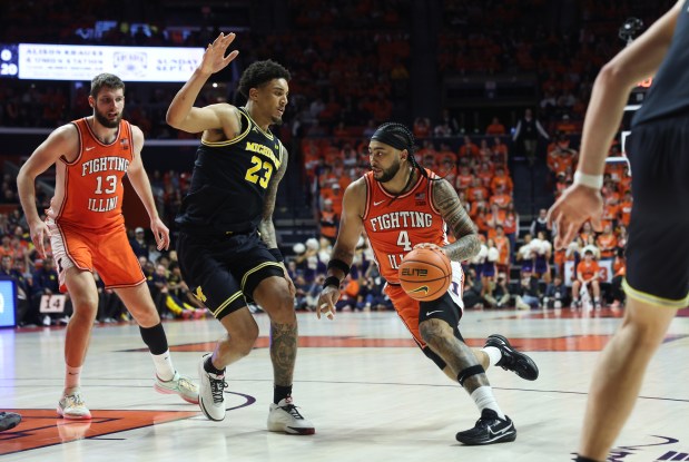 Illinois guard Kylan Boswell dribbles as Michigan forward Yaxel Lendeborg defends in the second half at State Farm Center on Feb. 27, 2026, in Champaign. (John J. Kim/Chicago Tribune)