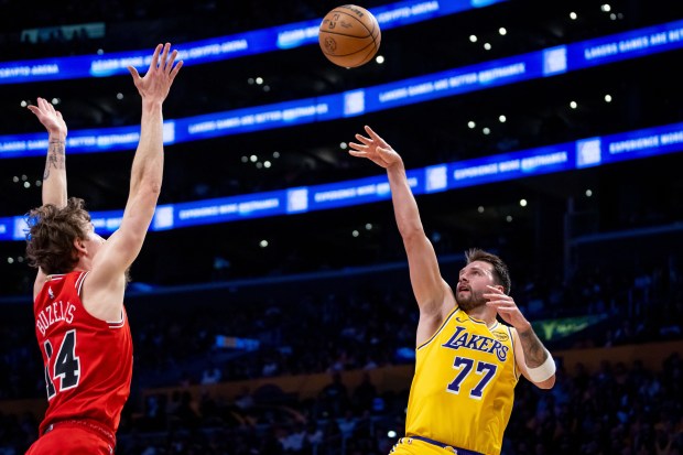 Lakers' Luka Dončić  shoots over the Bulls' Matas Buzelis during the first half on March 12, 2026, in Los Angeles. (Ethan Swope/AP)