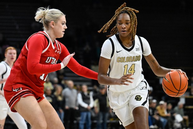 Colorado Buffaloes' Jade Masogayo, right, drives around Utah Utes' Chyra Evans, left, at the CU Events Center in Boulder on Tuesday, Feb. 24, 2026. (Matthew Jonas/Staff Photographer)