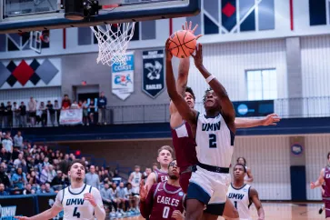 Photo of Freshman guard Josh Sewordor driving to the basket