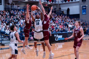 Photo of Junior guard Kaden Bates drives to the basket