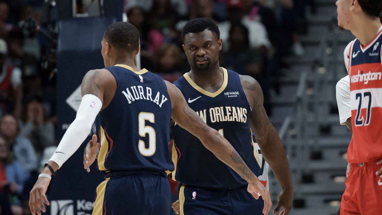New Orleans Pelicans forward Zion Williamson (1) reacts to a basket with guard Dejounte Murray (5) against the Washington Wizards during the first half at Smoothie King Center.