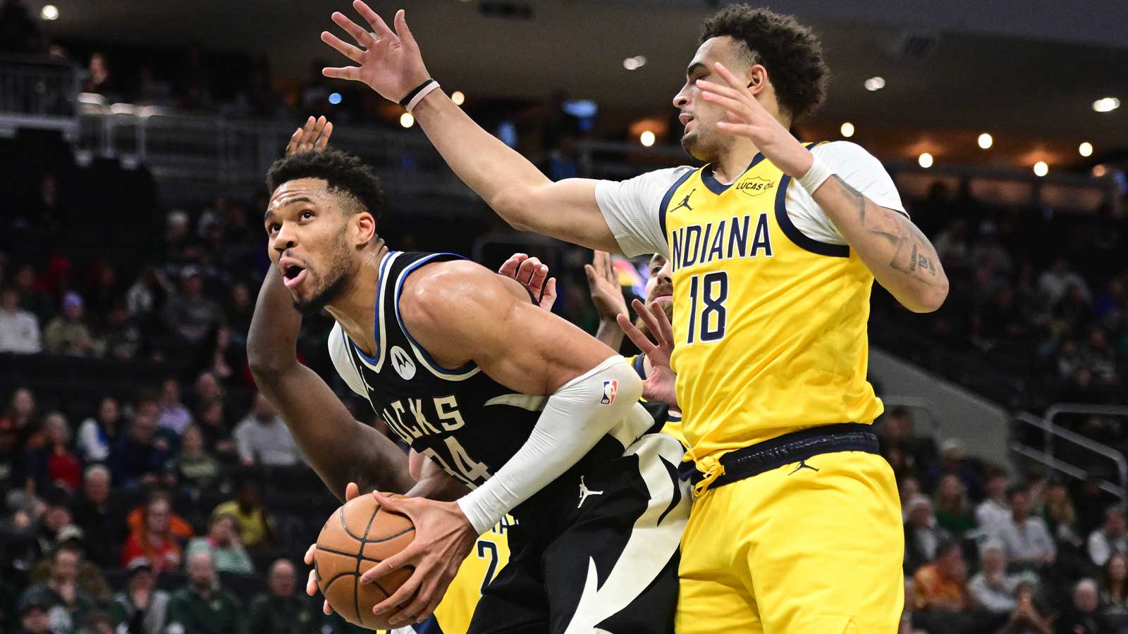 Milwaukee Bucks forward Giannis Antetokounmpo (34) looks for a shot against Indiana Pacers forward Jalen Slawson (18) in the second quarter at Fiserv Forum.