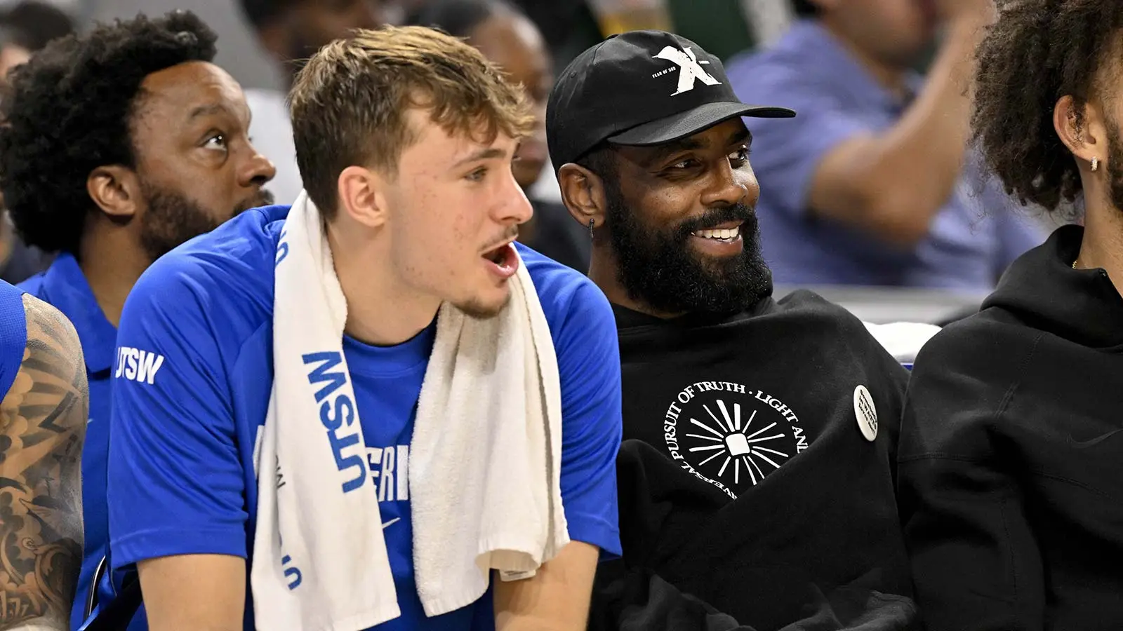 Dallas Mavericks forward Cooper Flagg (left) and guard Kyrie Irving (right) watch the game against the Oklahoma City Thunder during the second half at Dickie's Arena.