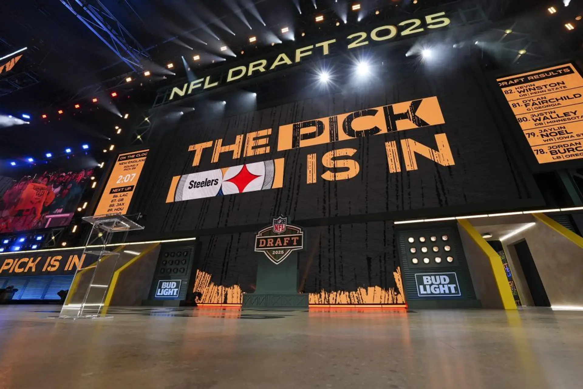 An empty stage at the NFL Draft shows a Steelers logo and the words "THE PICK IS IN" on the screen.