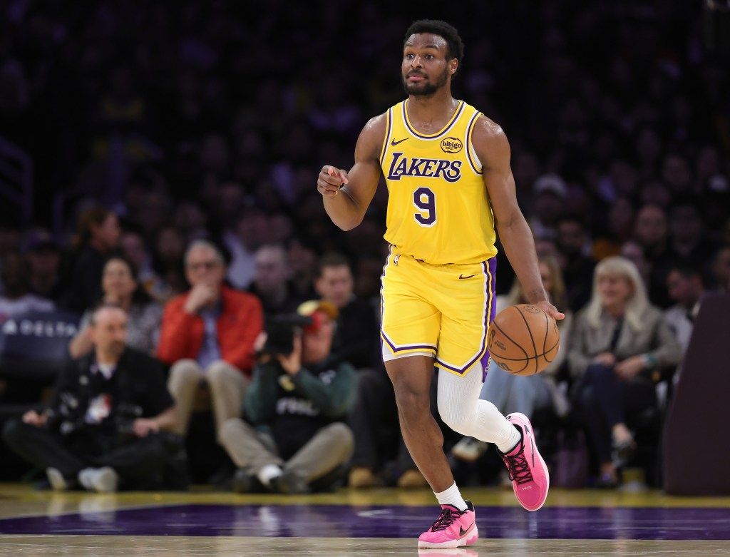 Bronny James dribbling the basketball in a Lakers uniform.