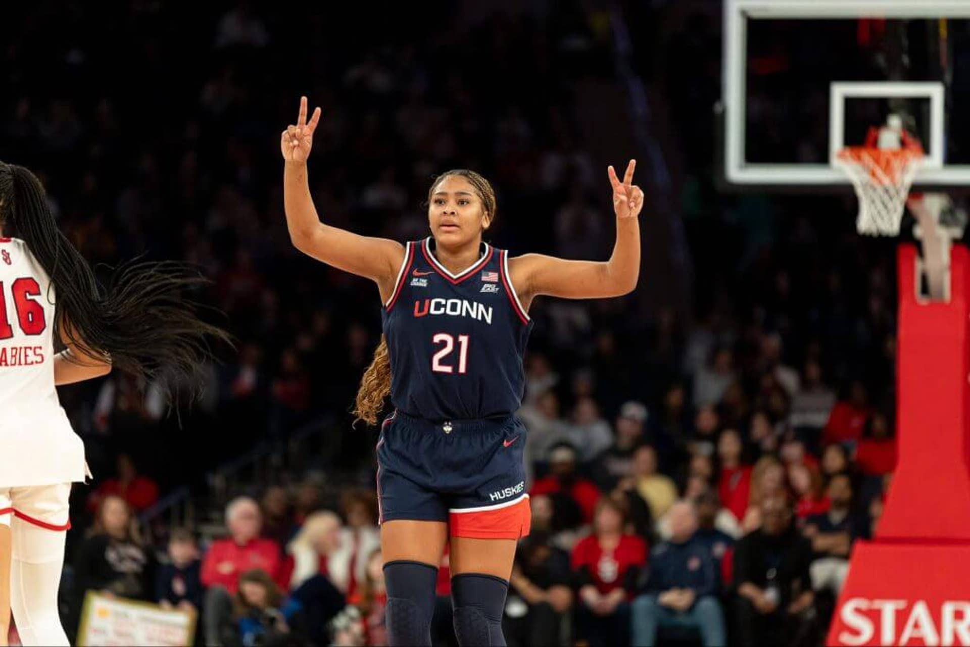 UConn forward Sarah Strong raises two fingers on each hand on the court during the second half of a win against St. John's earlier this week.