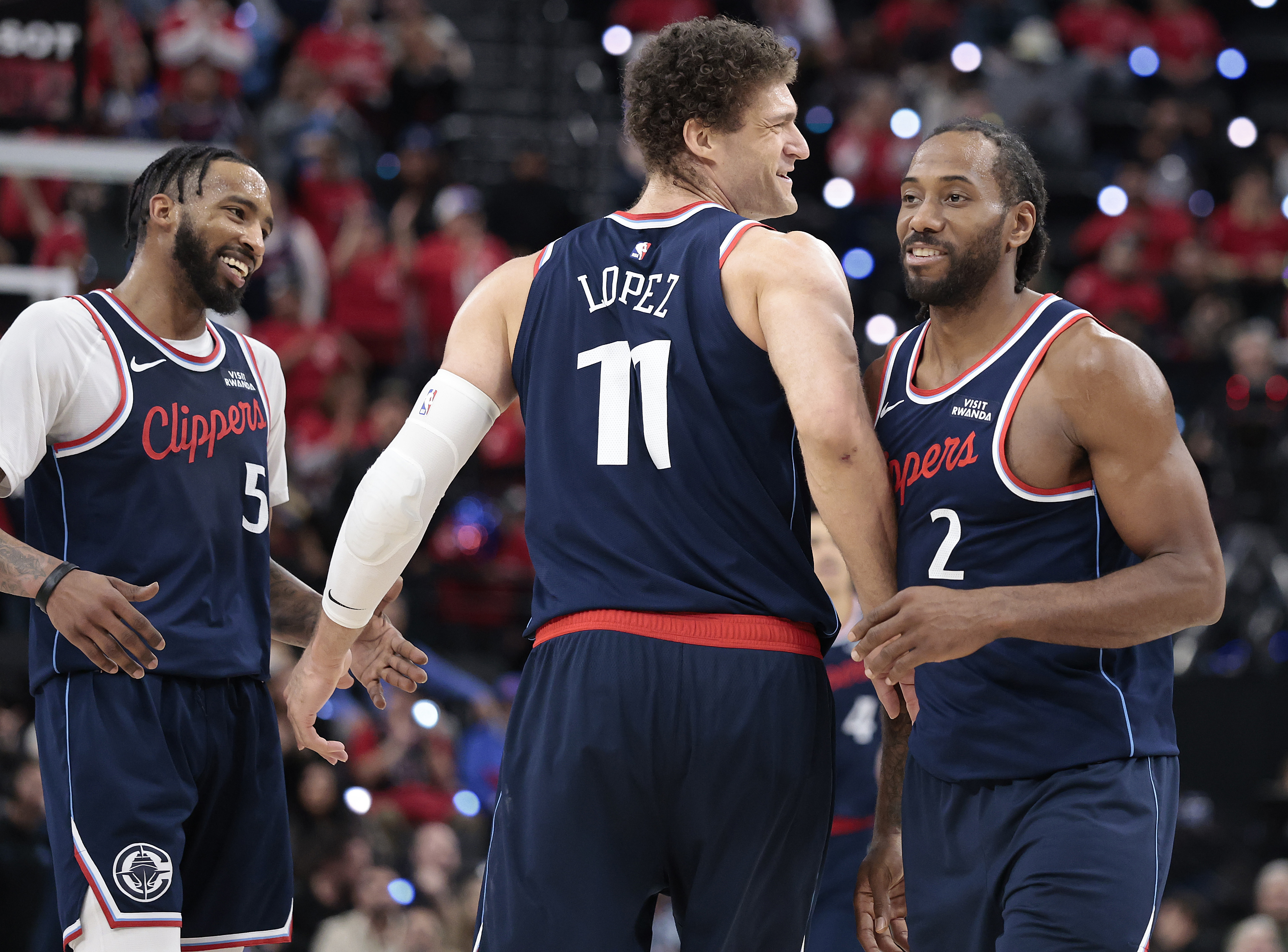 The Clippers’ Brook Lopez (11) and Kawhi Leonard, right, celebrate...