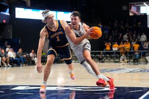 WASHINGTON, DC - MARCH 08: Monmouth Hawks Guard Jack Collins (13) drives the ball against Drexel Dragons Forward Victor Panov (1) during the second half of the CAA Men's Basketball Quarterfinals between the Drexel Dragons and the Monmouth Hawks on March 8, 2026, at CareFirst Arena in Washington DC. (Photo by Gregory Fisher/Icon Sportswire via Getty Images)