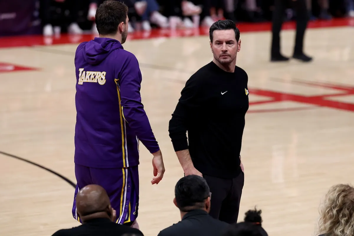 Head coach JJ Redick talks to Luka Doncic during Lakers game