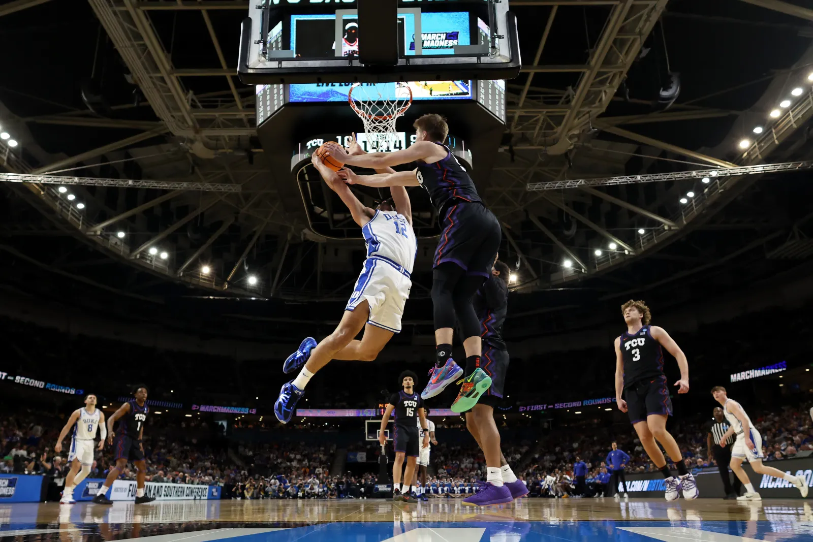Cameron Boozer #12 of the Duke Blue Devils shoots the ball against Tanner Toolson #55 of the Texas Christian University Horned Frogs during the first half in the second round of the 2026 NCAA Men's Basketball Tournament at Bon Secours Wellness Arena on March 21, 2026 in Greenville, South Carolina.