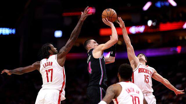 Tyler Herro #14 of the Miami Heat shoots the ball against Tari Eason #17, Reed Sheppard #15, and Jabari Smith Jr. #10 of the Houston Rockets during the second quarter of the game between the Miami Heat and the Houston Rockets at Toyota Center on March 21, 2026 in Houston.