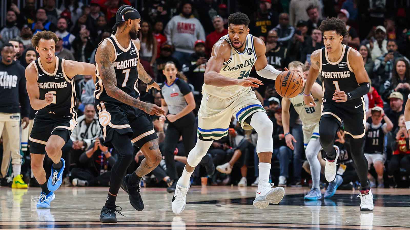 Milwaukee Bucks forward Giannis Antetokounmpo (34) steals the ball against Atlanta Hawks guard Dyson Daniels (5), guard Nickeil Alexander-Walker (7) and forward Jalen Johnson (1) during the fourth quarter at State Farm Arena.