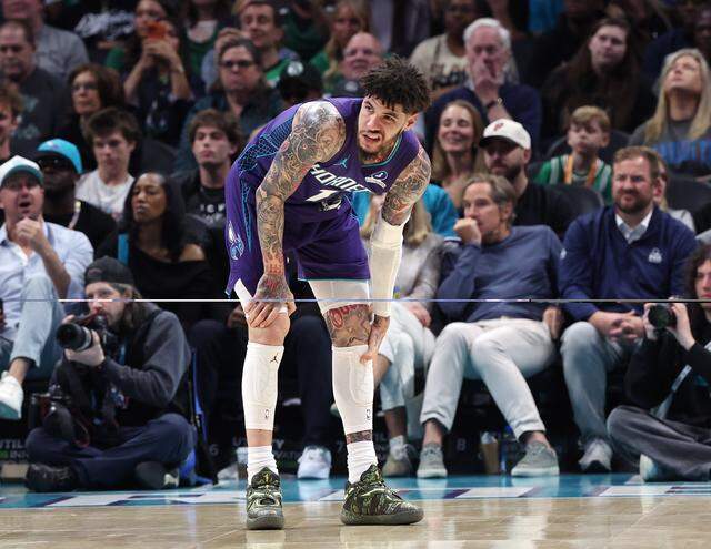Charlotte Hornets guard LaMelo Ball rubs his left leg during action against the Boston Celtics at Spectrum Center in Charlotte, NC on Sunday, March 29, 2026.
