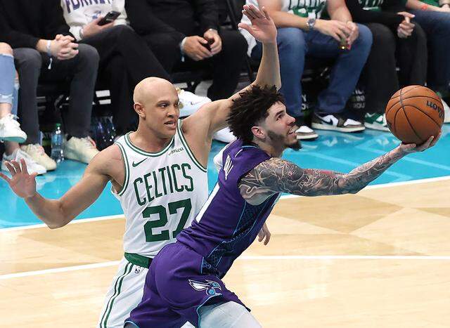 Charlotte Hornets guard LaMelo Ball, right, drives around Boston Celtics forward Jordan Walsh, left, for a shot during action at Spectrum Center in Charlotte, NC on Sunday, March 29, 2026. The Celtics defeated the Hornets 114-99.