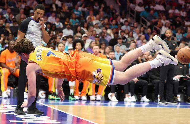 Charlotte Hornets forward Kon Knueppel dives out of bounds after attempting to save the ball during Saturday’s action against the Memphis Grizzlies at Spectrum Center. The Hornets defeated the Grizzlies 124-101.