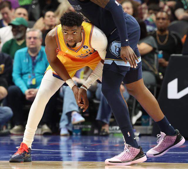 Charlotte Hornets guard Brandon Miller, left, keeps his eyes on the ball as Memphis Grizzlies forward GG Jackson II, right, towers over him during action at Spectrum Center in Charlotte, North Carolina, on Saturday, March 21, 2026. The Hornets defeated the Grizzlies 124-101.