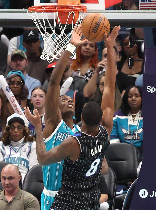 Charlotte Hornets center Moussa Diabate, left, looks to block a shot by Orlando Magic forward Jamal Cain during Thursday’s action at Spectrum Center.