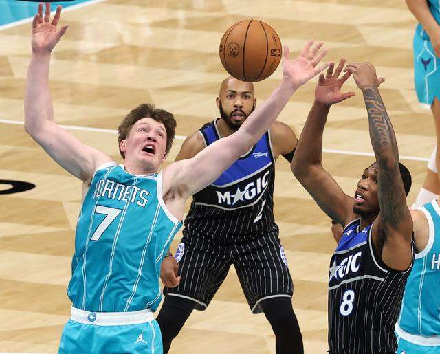 Charlotte Hornets forward Kon Knueppel, left, fights for control of a rebound with the Orlando Magic’s Jamal Cain during Thursday’s action at Spectrum Center.