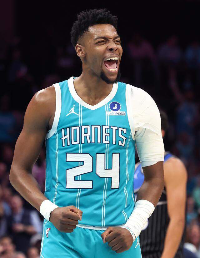 Charlotte Hornets guard Brandon Miller celebrates with the fans after Orlando Magic head coach Jamahl Mosley received two technicals and an ejection from Thursday’s game at Spectrum Center.