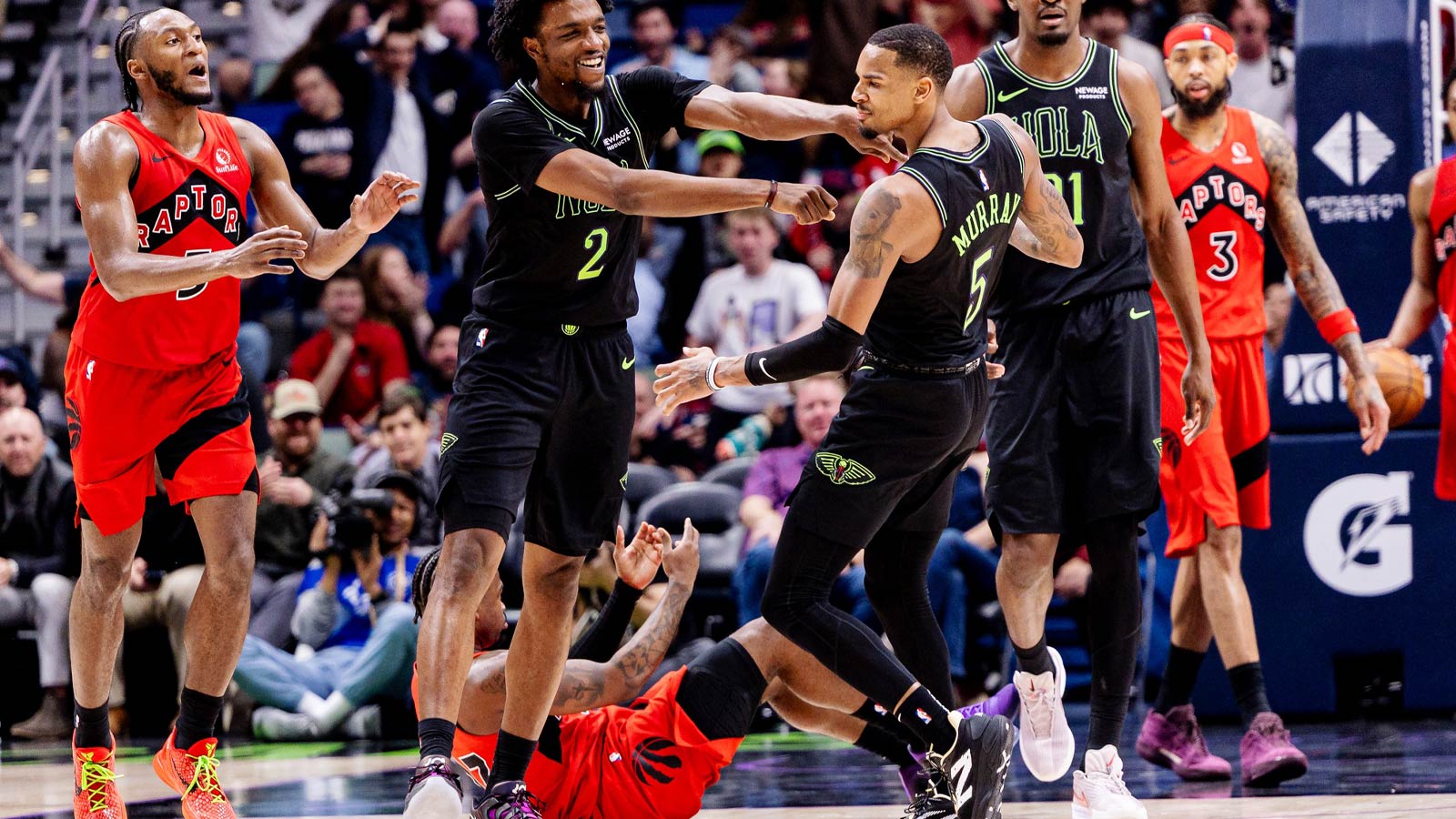 New Orleans Pelicans forward Herbert Jones (2) shoves guard Dejounte Murray (5) after making a three point basket against Toronto Raptors guard Jamal Shead (23) during the second half at Smoothie King Center.
