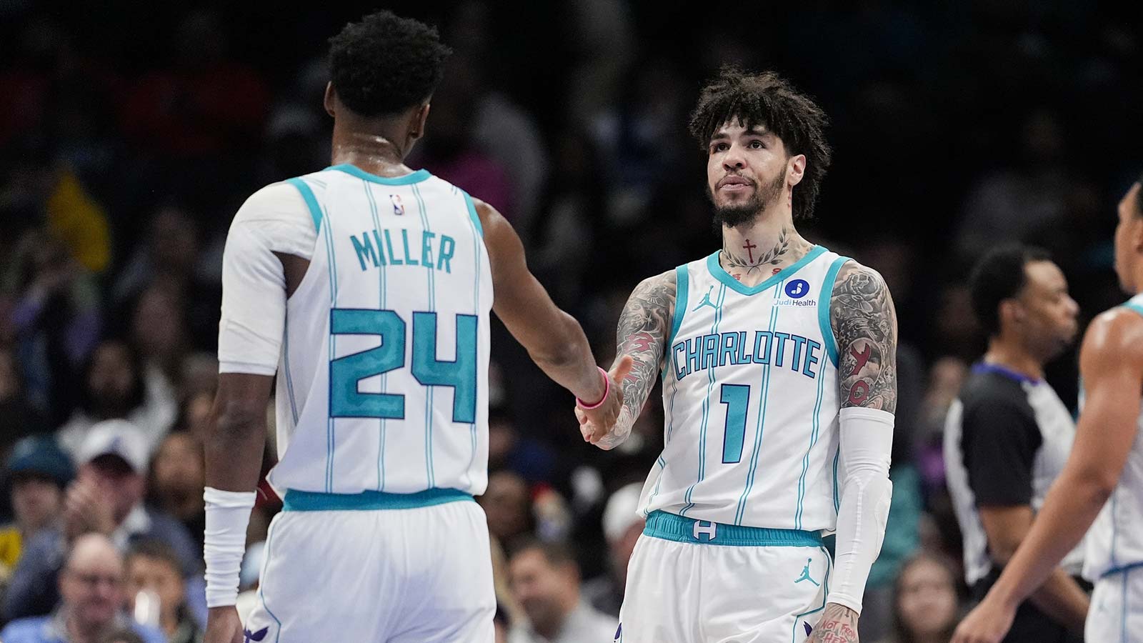 Hornets' LaMelo Ball (1) and Brandon Miller (24) high five