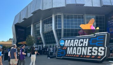 Sports fans line up outside Golden 1 Center and March Madness signage