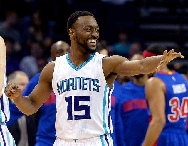 Charlotte Hornets guard Kemba Walker reaches out to congratulate a teammate following a score in 2016. Walker ended his career as the Hornets’ all-time leading scorer, surpassing Dell Curry by more than 2,000 points.