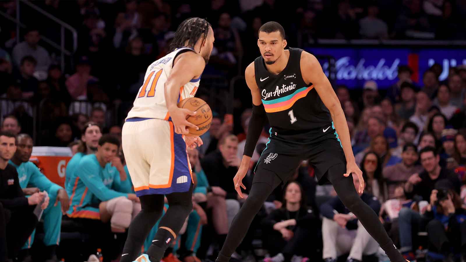 San Antonio Spurs forward Victor Wembanyama (1) defends New York Knicks guard Jalen Brunson (11) during the third quarter at Madison Square Garden.