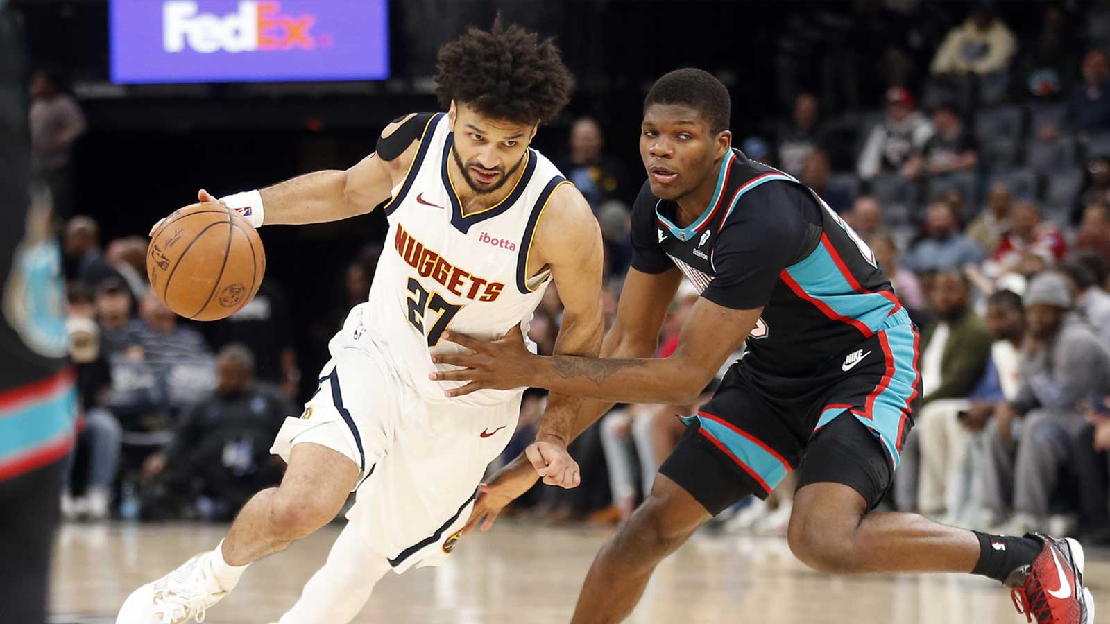  Denver Nuggets guard Jamal Murray (27) dribbles as Memphis Grizzlies forward Cedric Coward (23) defends during the fourth quarter at FedExForum. 