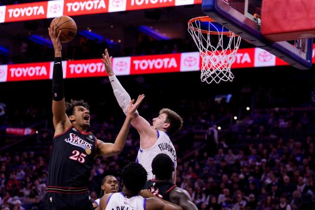 Philadelphia 76ers' Dom Barlow shoots the ball over Utah Jazz's Kyle Filipowski during the first half Wednesday, March 4, 2026, in Philadelphia. (AP Photo/Chris Szagola)