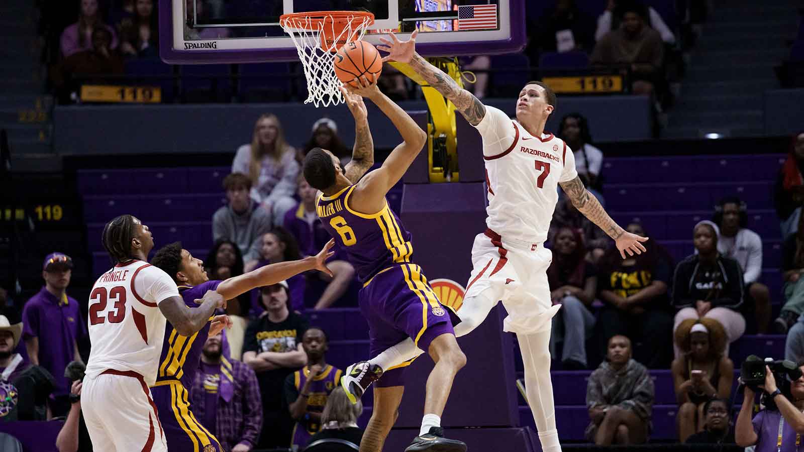 LSU Tigers forward Robert Miller III (6) has his shot blocked by Arkansas Razorbacks forward Trevon Brazile (7) during the first half at Smoothie King Center.