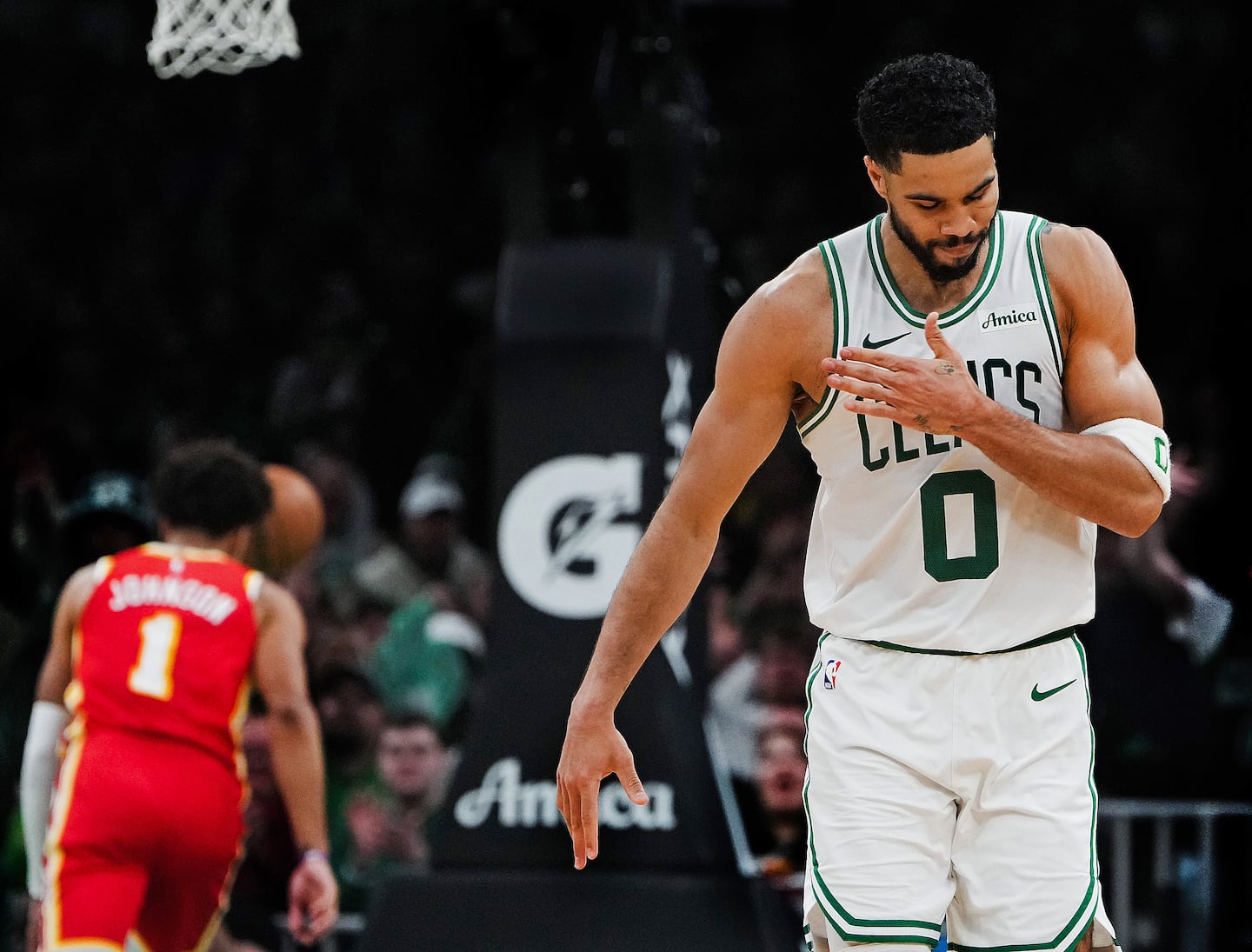 Celtics forward Jayson Tatum  slaps his chest after draining a 3-pointer for a 100-89 lead  during the fourth quarter.