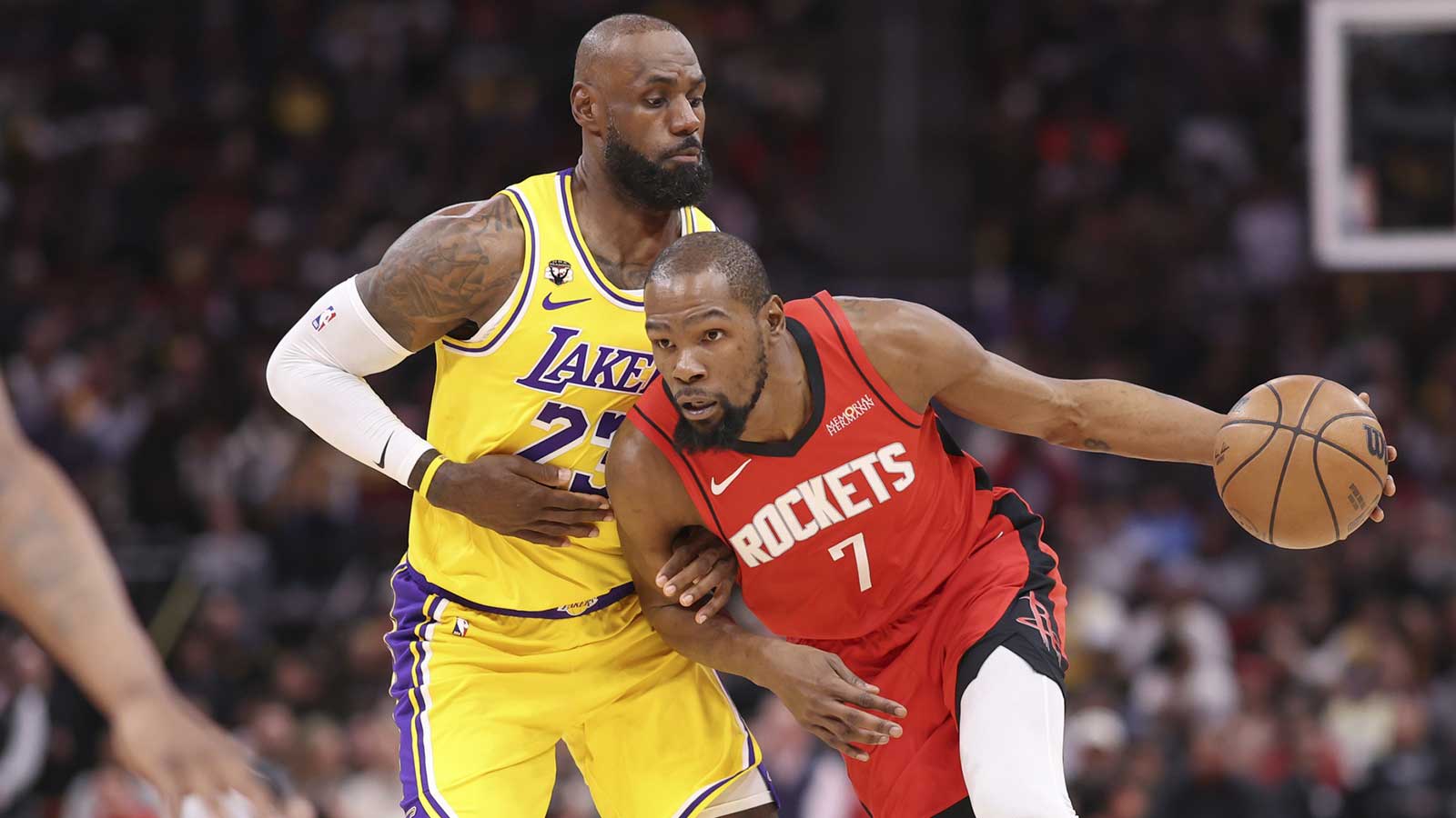 Houston Rockets forward Kevin Durant (7) dribbles the ball as Los Angeles Lakers forward LeBron James (23) defends during the first quarter at Toyota Center.