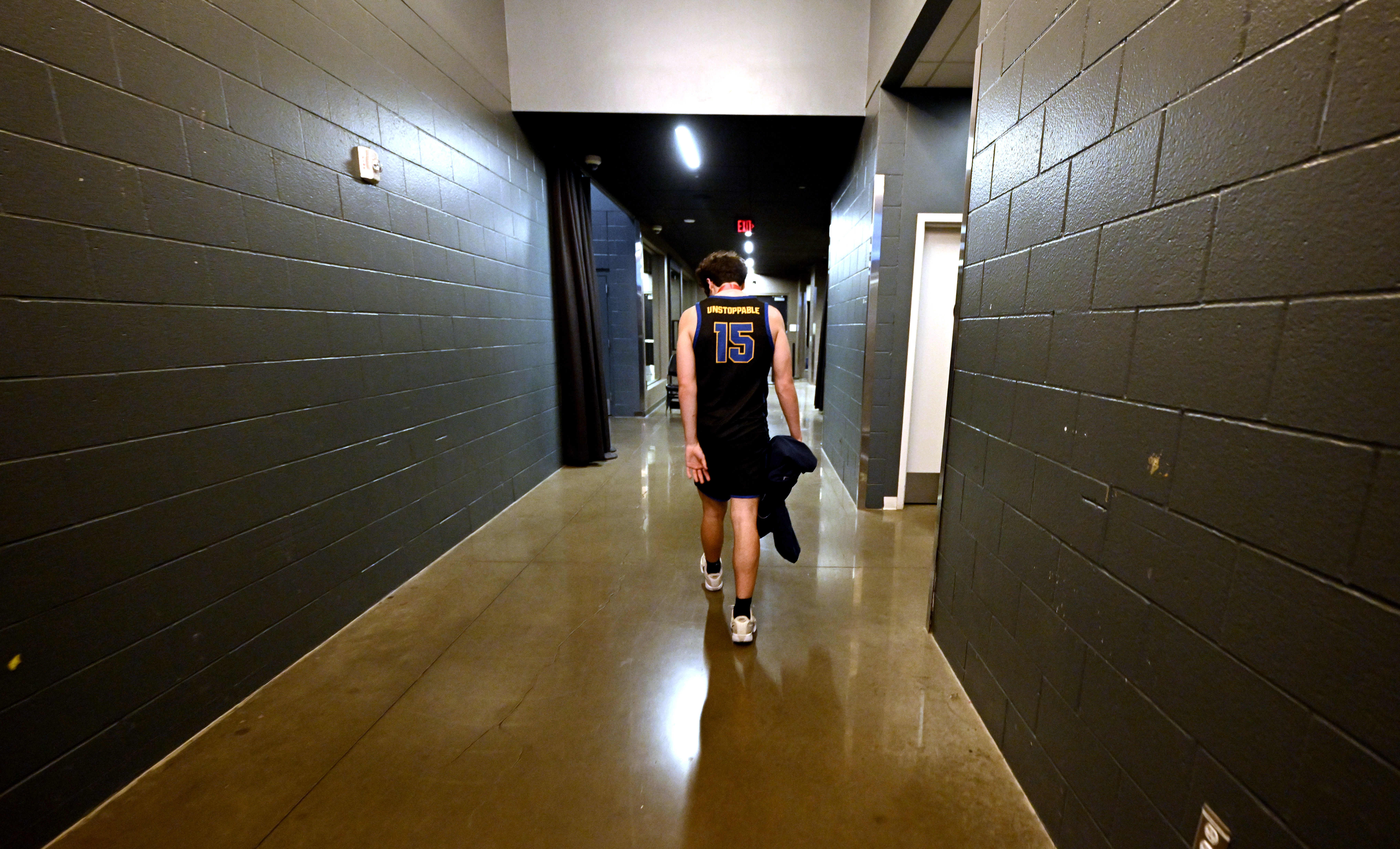 Tyler Elliott #15 of the San Juan Hills Stallions walks...