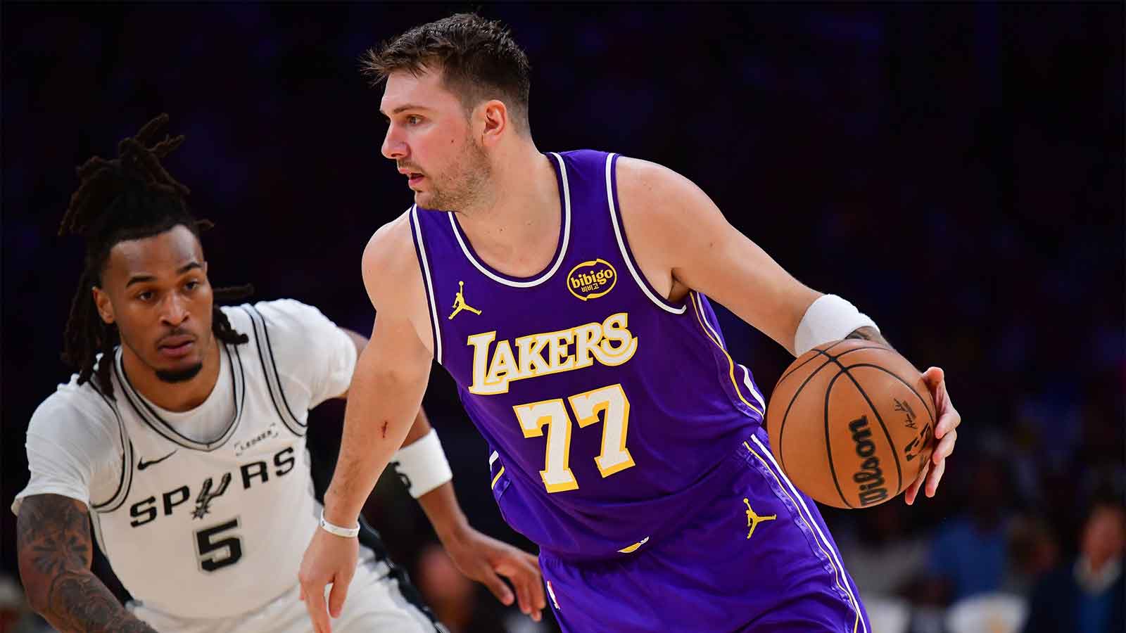 ; Los Angeles Lakers guard Luka Doncic (77) moves the ball against San Antonio Spurs guard Stephon Castle (5) during the first half at Crypto.com Arena.