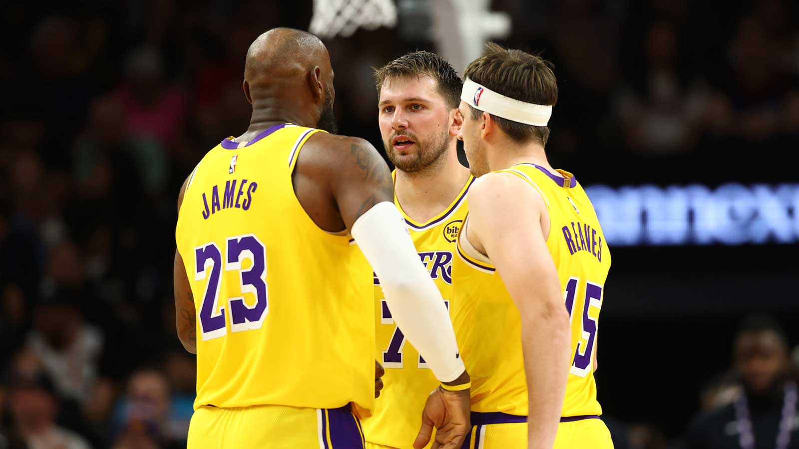 Los Angeles Lakers forward LeBron James (23) with guard Luka Doncic (77) and guard Austin Reaves (15) against the Phoenix Suns at Mortgage Matchup Center
