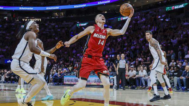Miami Heat guard Tyler Herro (14) gets by Brooklyn Nets guard/forward Terance Mann (14) to score in the first half of their NBA basketball game at the Kaseya Center in Miami, Florida, on Thursday, March 5, 2026.