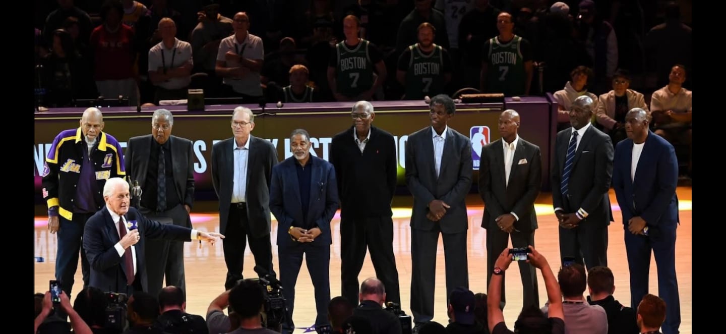 Ted Lorden and his two sons, wearing No. 7 Boston jerseys in background, photobombed Lakers legends with the Celtics in Los Angeles.
