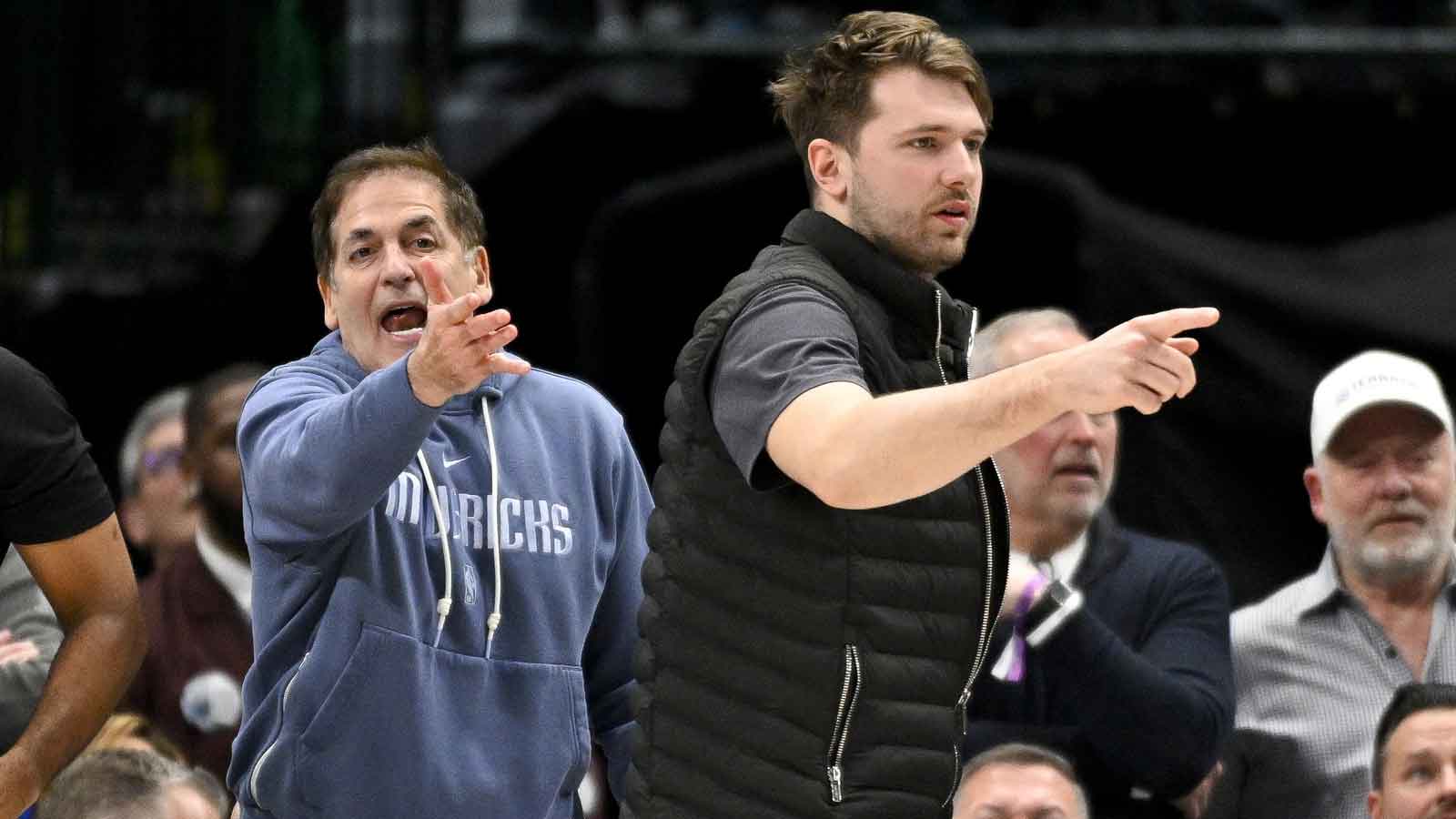 Mavericks guard Luka Doncic (right) and Mark Cuban (left) argue a call