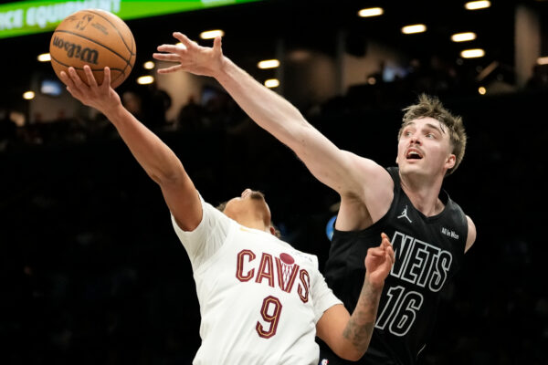 Cleveland Cavaliers guard Craig Porter Jr. (9) attempts to shoot past Brooklyn Nets forward Grant Nelson (16) during the second half of an NBA basketball game, Sunday, March 1, 2026, in New York. (AP Photo/Yuki Iwamura)