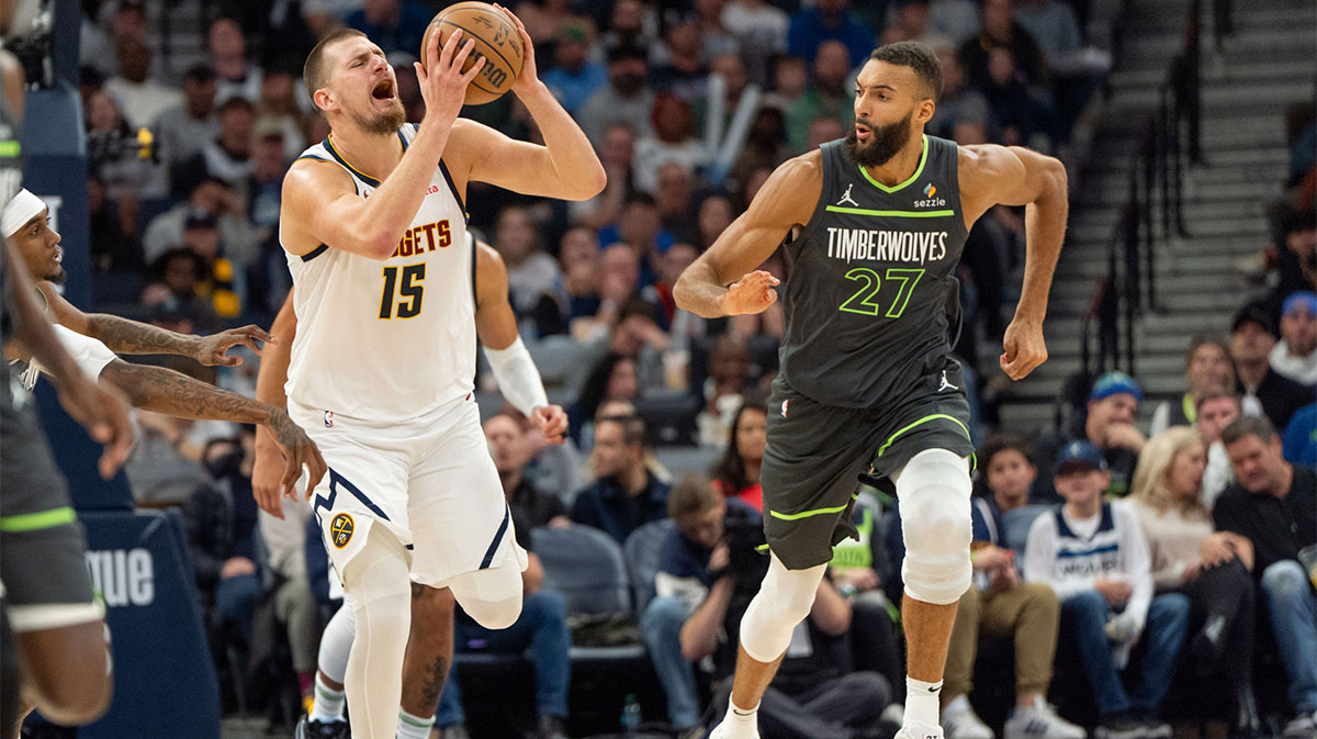 Denver Nuggets center Nikola Jokic (15) tries to draw a foul on Minnesota Timberwolves forward Jaden McDaniels (3) in the fourth quarter at Target Center.