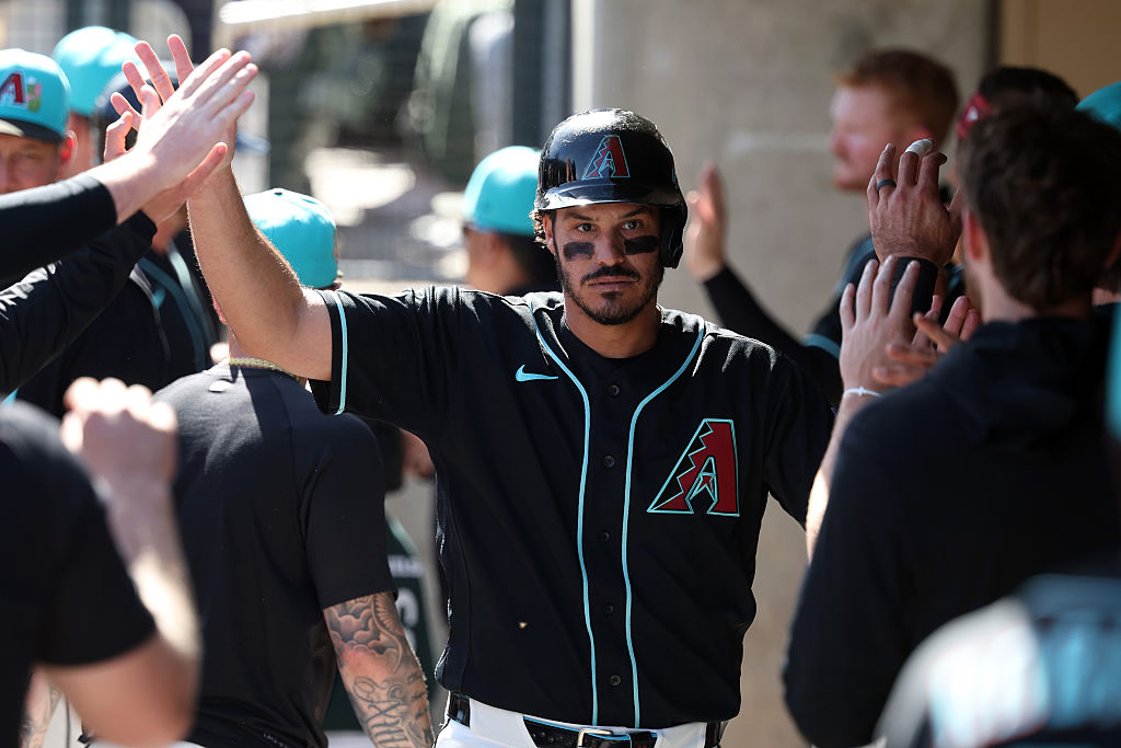 nolan arenado high-fives teammates