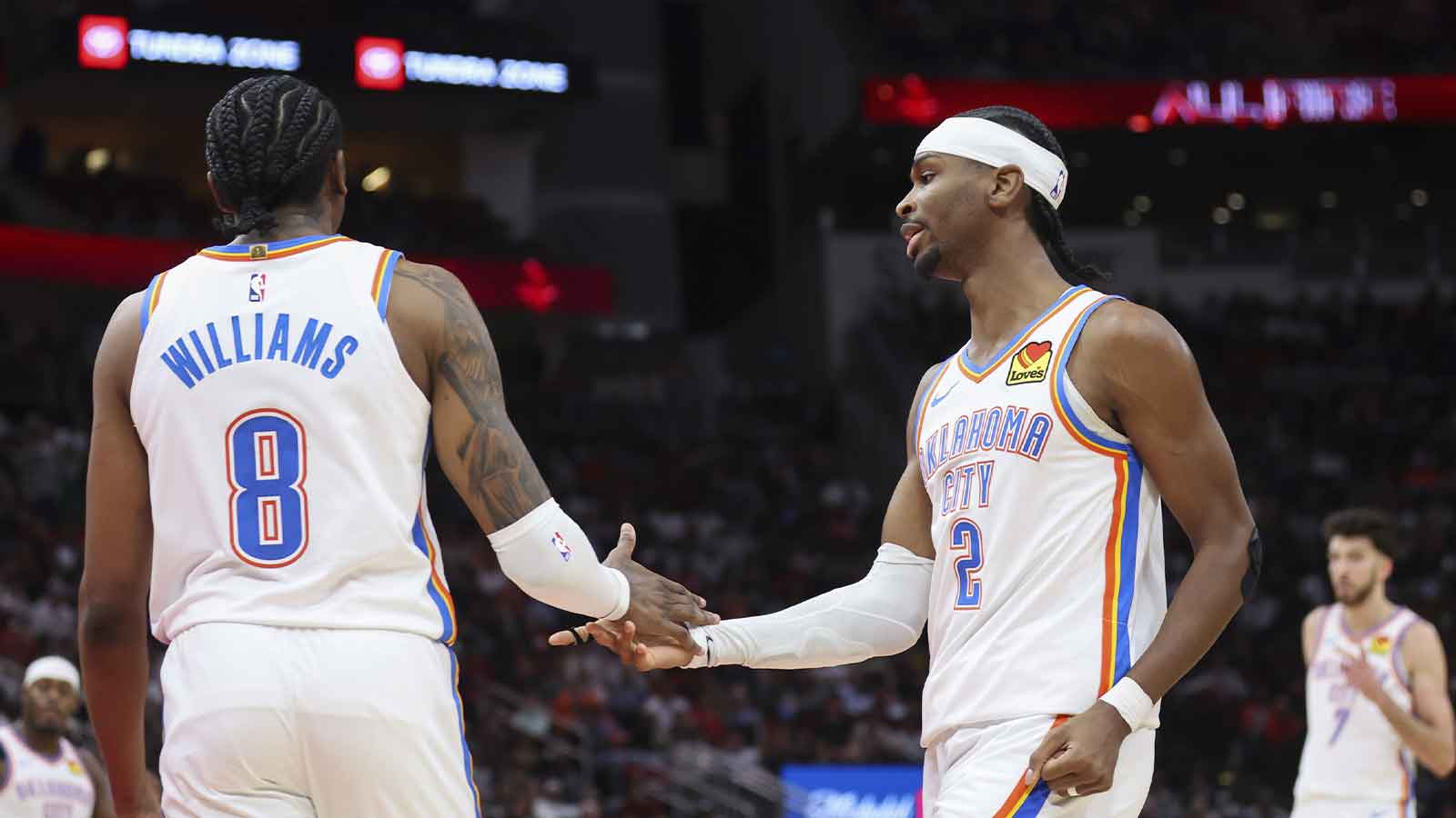 Oklahoma City Thunder guard Jalen Williams (8) and guard Shai Gilgeous-Alexander (2) react after a play during the third quarter against the Houston Rockets at Toyota Center. Mandatory Credit: Troy Taormina-Imagn Images